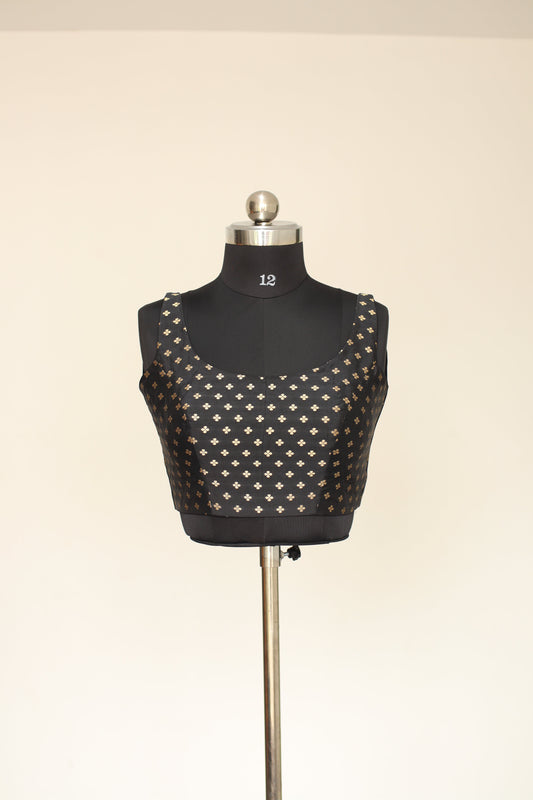 Black patterned garment on a mannequin with a beige background